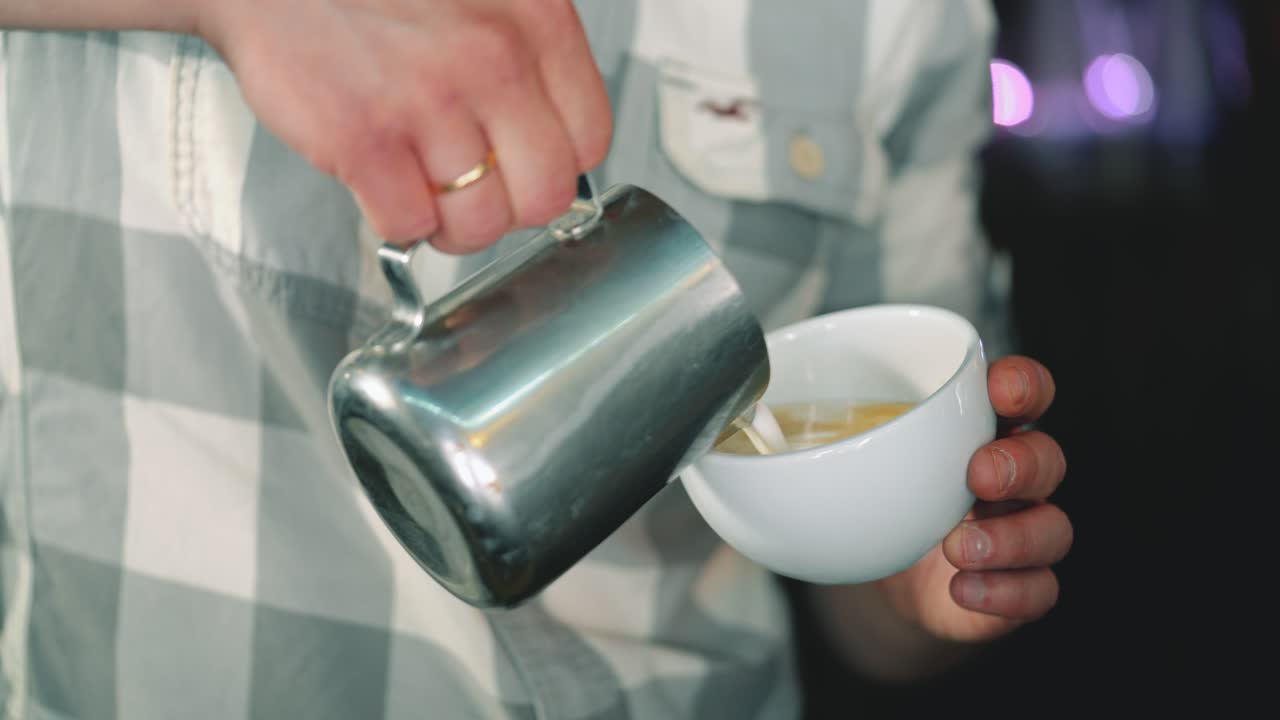 Barista makes a drawing on coffee. Coffee making latte art