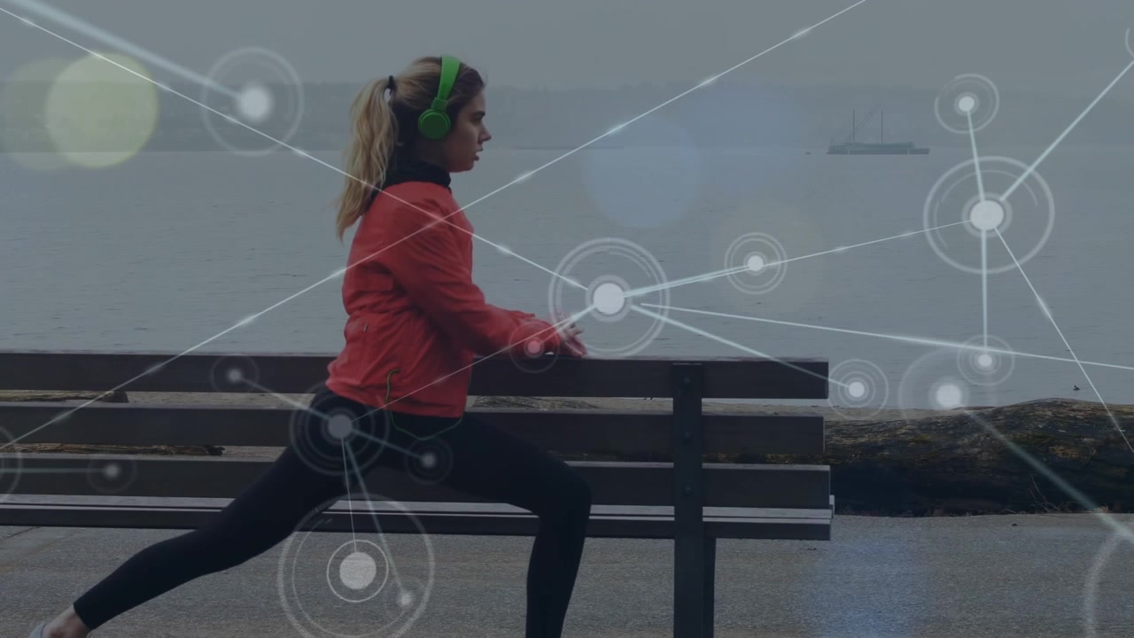 Animation of network of connections with icons over caucasian woman stretching