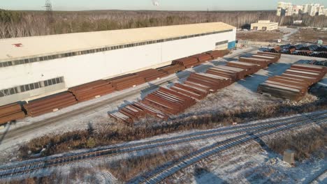 aerial view of round metal pipes in metal warehouse. outdoors storage site.