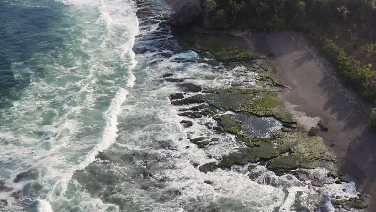 Aerial View of a Rocky Coastline with Waves
