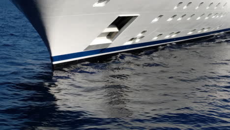 bow of a large ship sailing through deep blue water