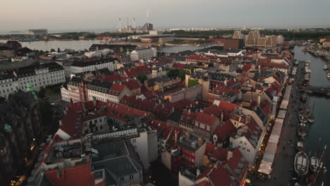 King's-Square-and-New-Harbor-Aerial-View-in-the-Evening,-Featuring-People-and-Cityscape-with-a-Charming-Illumination