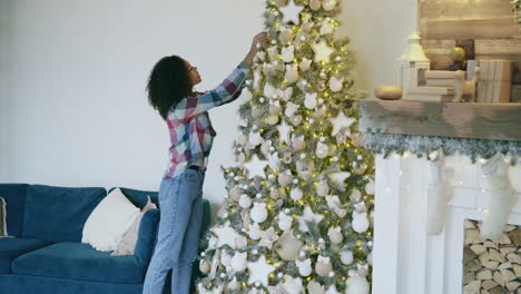 Woman decorating Christmas Tree
