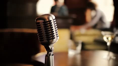 a captivating vintage microphone set against a cozy bar ambiance, perfect for live performances, showcasing the charm of classic entertainment venues