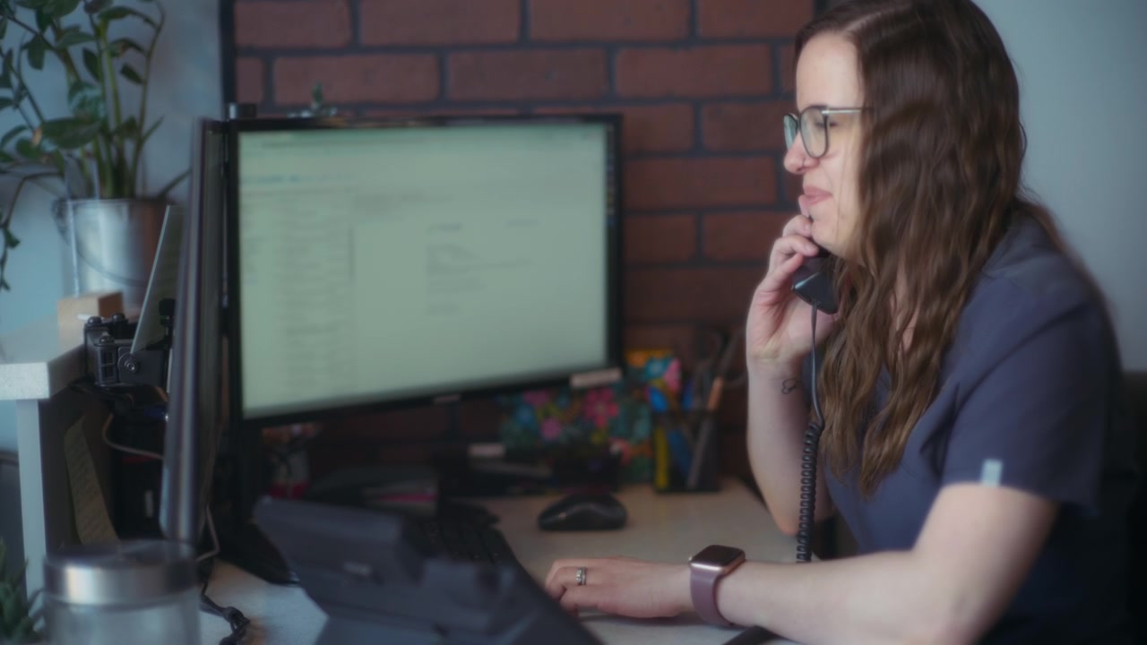 Receptionist ending a call with a client