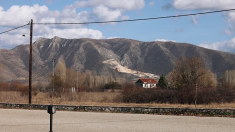 pan right smooth tripod movement, usa nevada desert landscape mountains view, private houses with red rooftops, scenic sky, sunny clear weather, 4k video