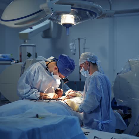 operating room with surgery in progress. medical team performing surgical operation in bright modern operating room