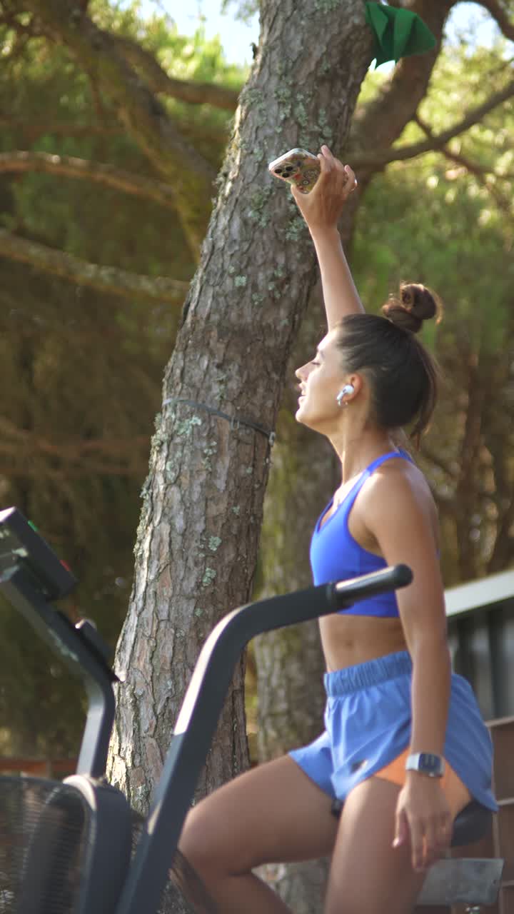 Woman exercising on exercise bike outdoors