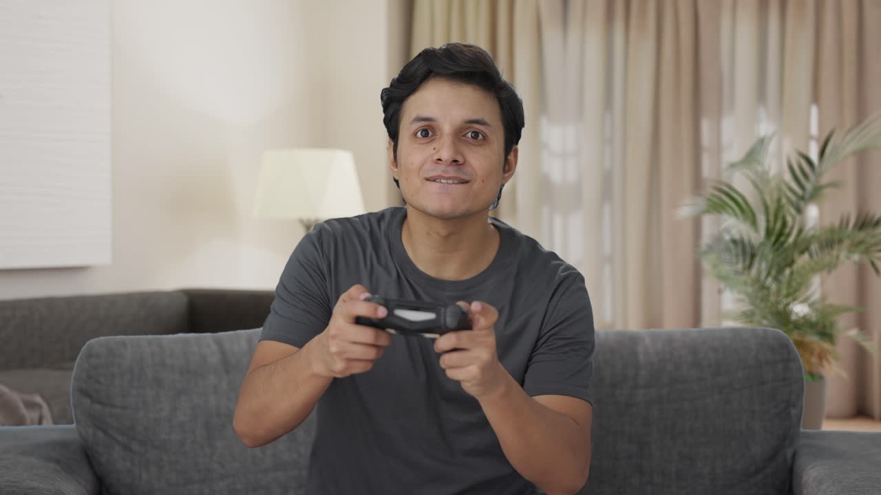 Indian man playing video games