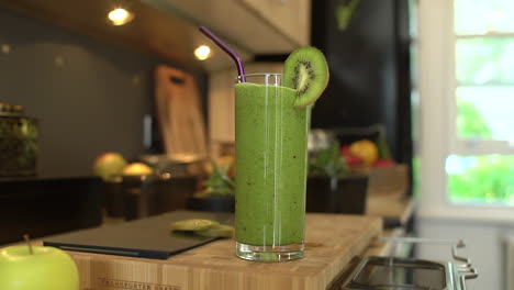 close up of female hand taking glass of smoothie