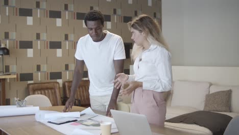 two project managers standing at table