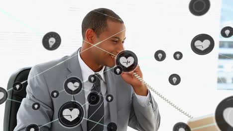Animation-of-digital-icons-over-biracial-businessman-talking-on-phone-showing-thumbs-up