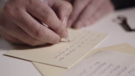 close up a hand, writing with ball pen on correspondence paper