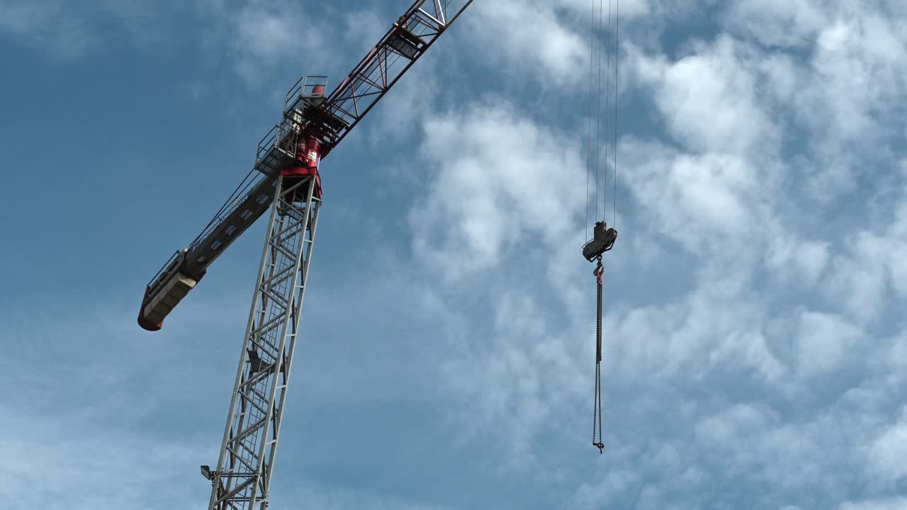 Bucharest, Romania - January 24, 2021: View of a crane machine moving with a blue, cloudy sky background