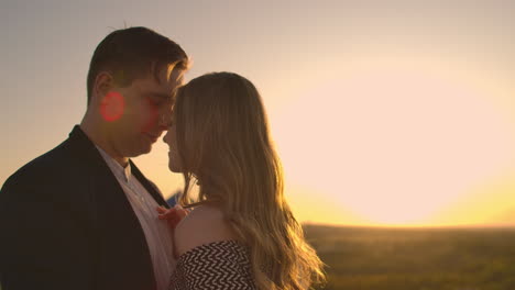 Young-couple-in-love-standing-on-the-roof-hug-and-closely-look-at-each-other.-Romantic-evening-on-the-roof-of-the-building.-A-date-on-the-roof-of-a-building-love.-Slow-motion