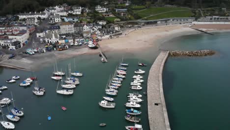 Aerial-Over-Pier-Wall-Alongside-The-Cobb-Marina-At-Lyme-Regis