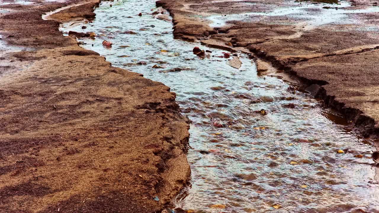 Stream flows through rocky terrain conveying tranquility and movement
