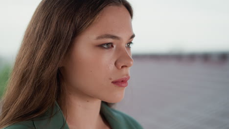 exhausted woman feels offence on rainy day closeup. pretty lady stands on roof seeking for tranquility and emotional pain relief. unstable mental health