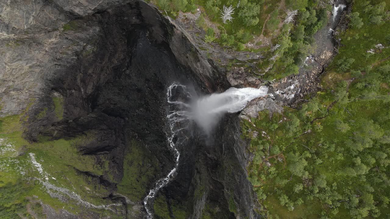 Aerial footage of Vettisfossen waterfall in Norway, showing the dramatic drop and lush greenery around the falls