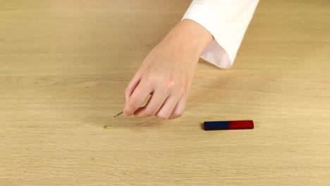 person assembling a simple magnetic device