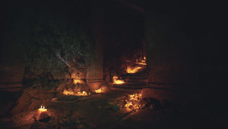 mysterious candlelit pathway in an ancient underground cavern