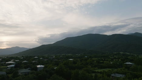 Orbit-Aerial-of-Rural-Georgia-Countryside-With-Lush-Greenery-and-Buildings