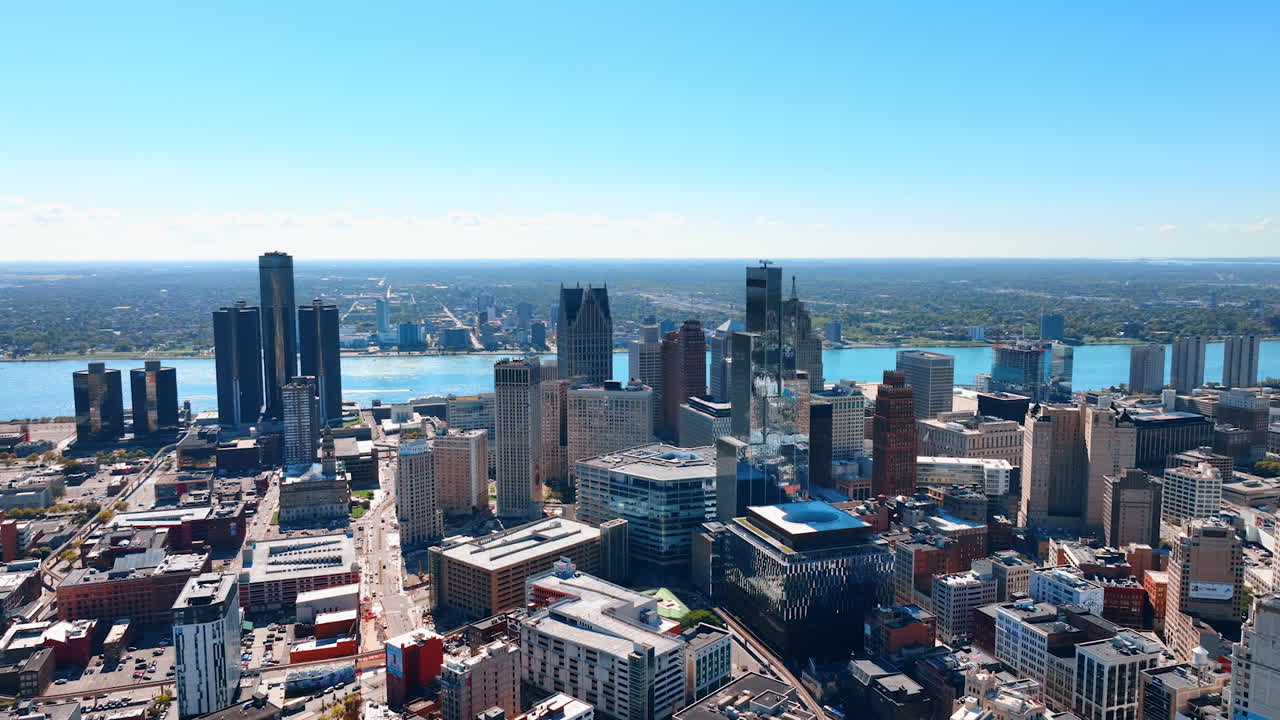 Detroit, USA, 28 July 2025: Detroit towers above the riverfront. Bright daytime skyline of Detroit with glass towers and the Detroit River shimmering behind