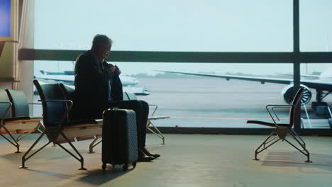 man waiting at airport terminal