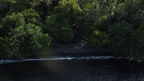 aerial moving wave on rural coastline bali