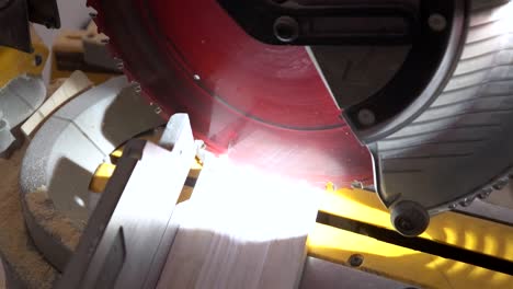 carpenter using a circular saw while cut wood in new house construction