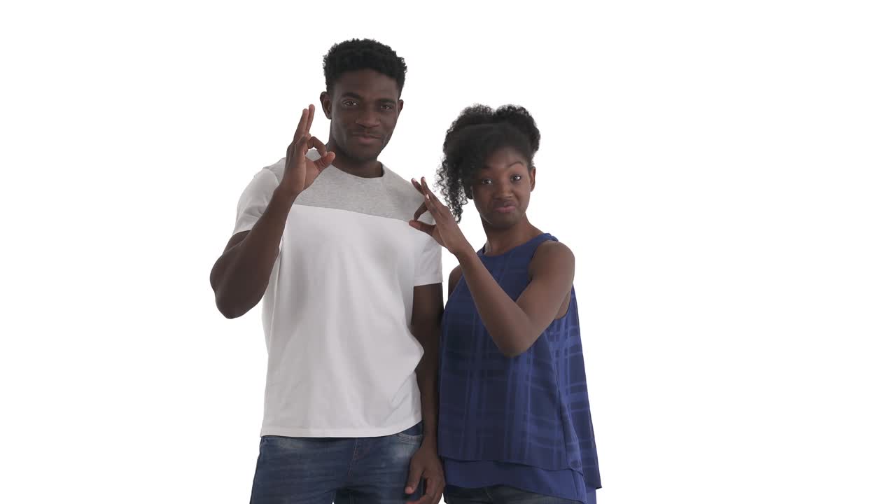 Portrait of young African american couple connecting thumb and forefinger in a circle and holding another fingers straight showing okay sign isolated on white background