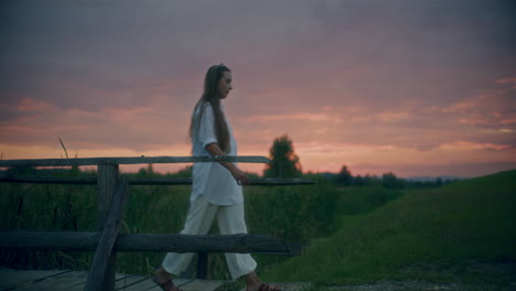 Depressed-Woman-Walking-On-A-Bridge-Dusk