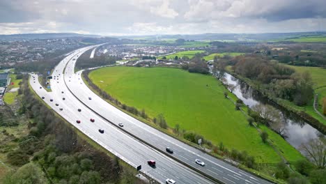 Aerial-drone-cinematic-video-footage-of-the-M1-Motorway-near-the-city-of-Wakefield,-West-Yorkshire,-UK