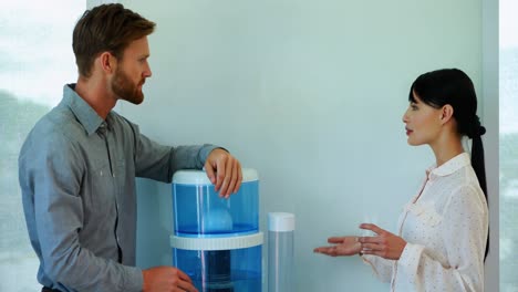 Colleagues-interacting-while-drinking-water