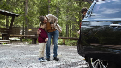 family getting ready to travel on big car