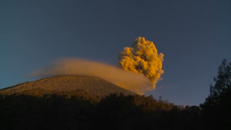 a large volcano erupts in a cloud of smoke and ash