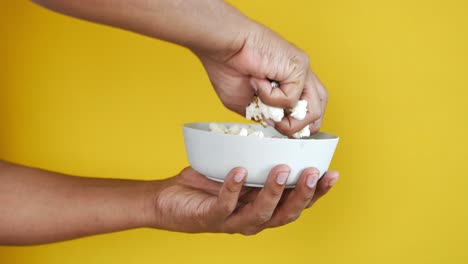 popcorn in a bowl on wooden des