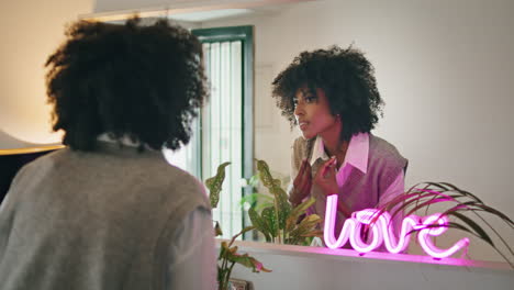 Girl-dancing-home-looking-in-mirror-close-up.-Relaxed-woman-admiring-reflection.