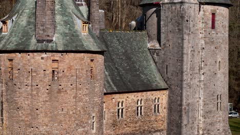 stunning close up drone footage of castell coch near cardiff, showcasing its fairytale architecture, lush woodland setting, and historic charm through cinematic aerial and scenic shots.