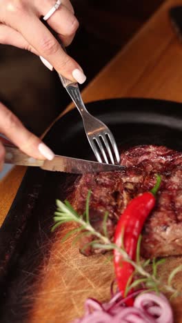 woman cutting a delicious steak