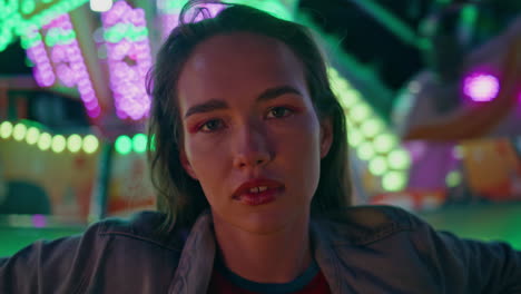 gorgeous woman posing night city festival closeup. beautiful teen resting neon