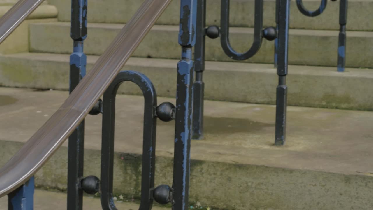 Old weathered stone steps ornate metal railings