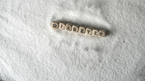 dice spelling diabetes falling into pile of sugar