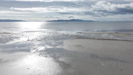 Low-aerial-track-of-the-Great-Salt-Lake,-Utah-on-a-sunny-spring-day