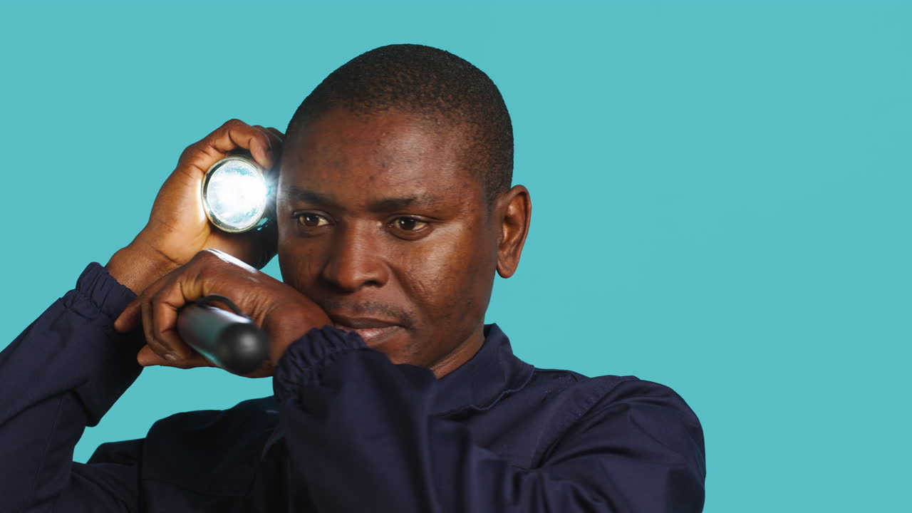 Close up of patrolling agent using truncheon and lantern to evict intruders