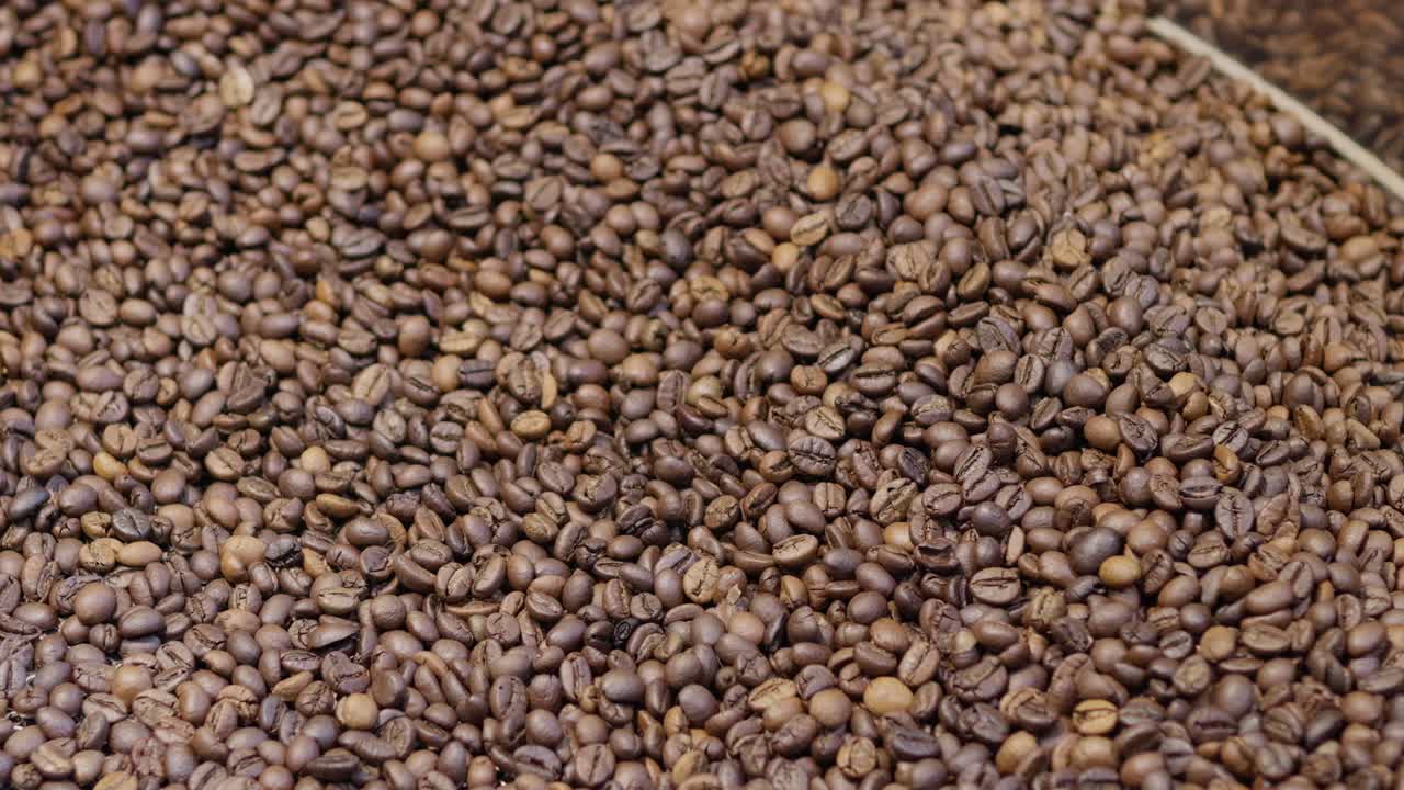 Explore the intricate process of coffee roasting showcasing the transformation of beans in a bustling roastery.