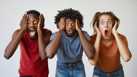 a group of three people with their hands on their heads