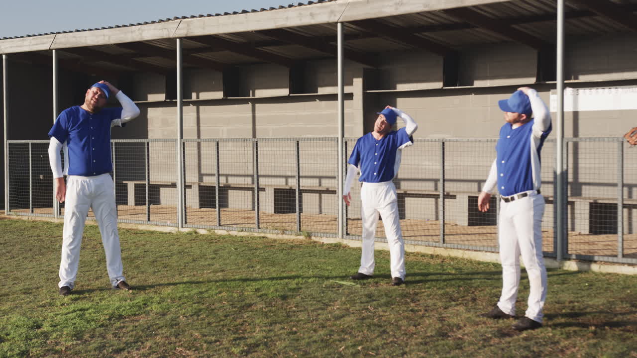 Baseball players stretching and warming up on field before game