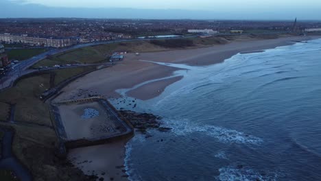 Tynemouth Longsands beach with relaxing waves as sun rises on spring morning