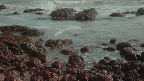 Waves-gently-wash-over-rocky-coastline-creating-a-serene-and-peaceful-scene